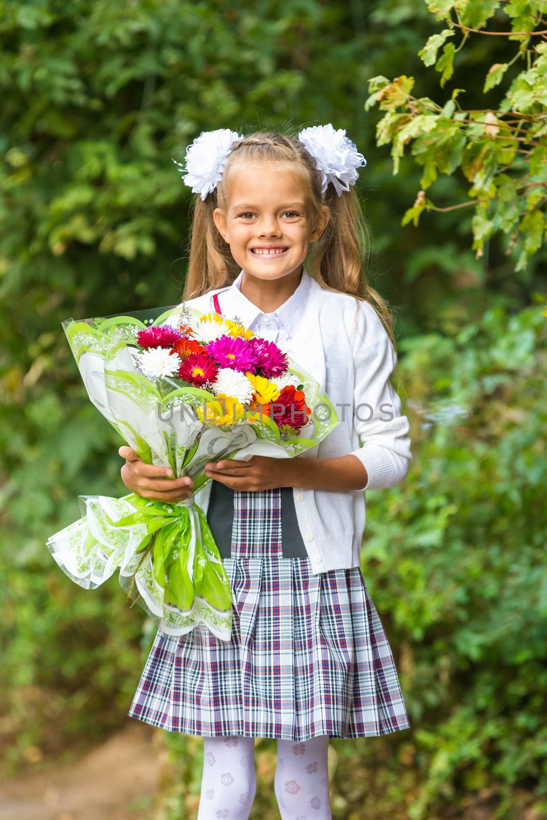 First grader with a bouquet of flowers smiling happily by Madhourse