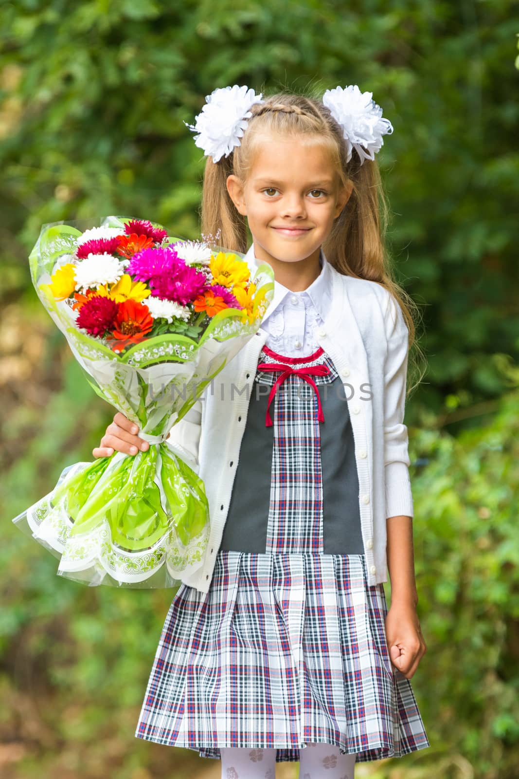 Portrait of a seven-year first-grade girls going to school on September 1 in