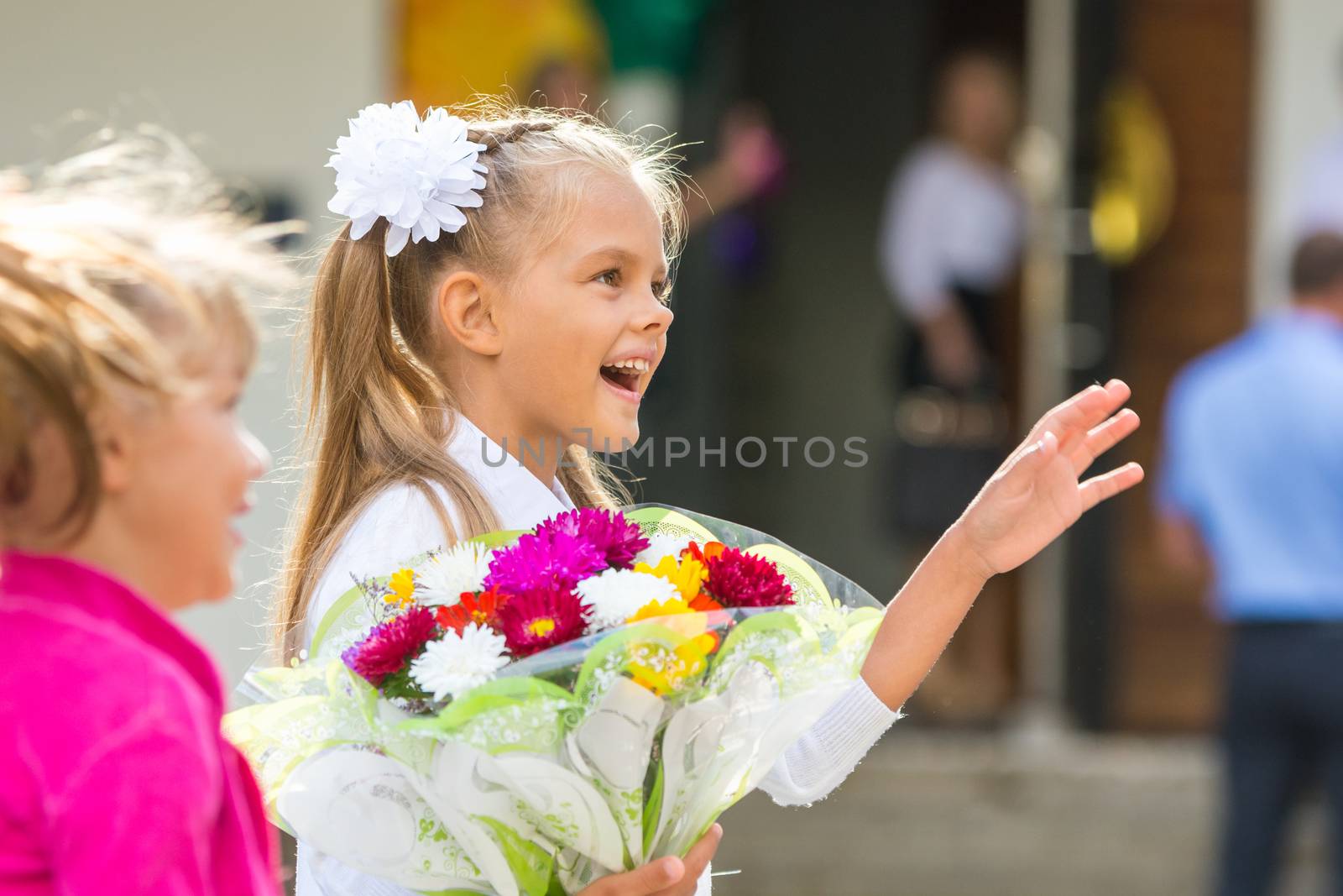 First-grader at the school the first of September in greeting waving his girlfriend