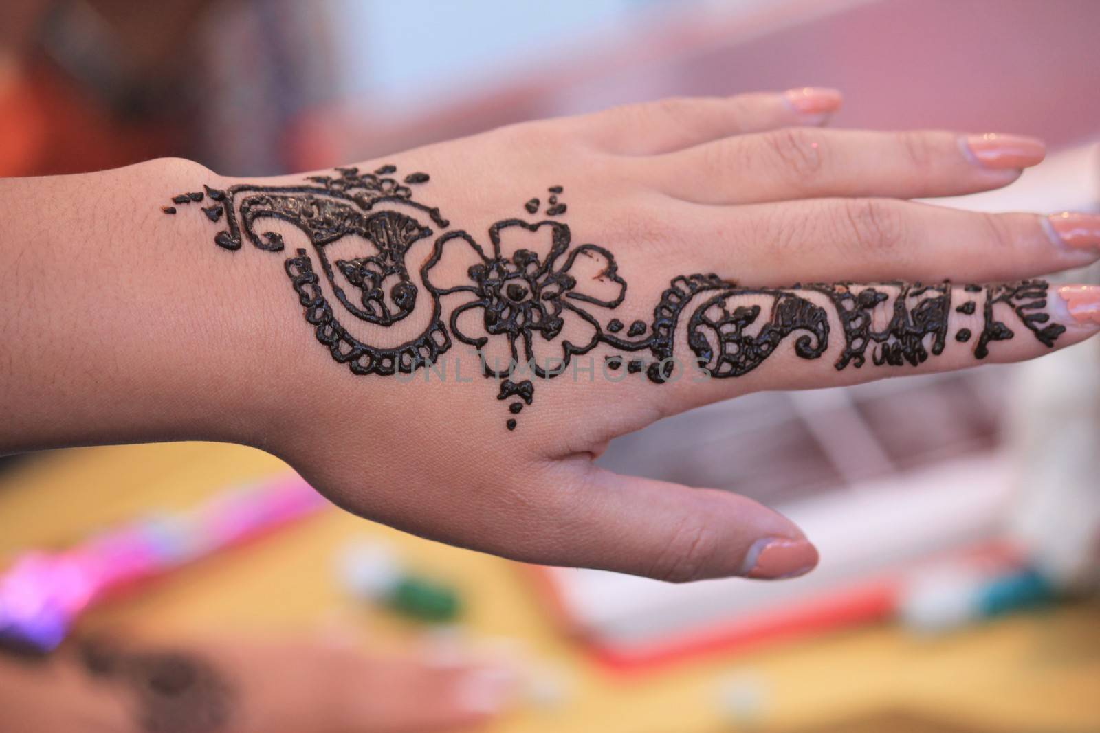 Indian Henna tattoo being applied to hand by cheekylorns