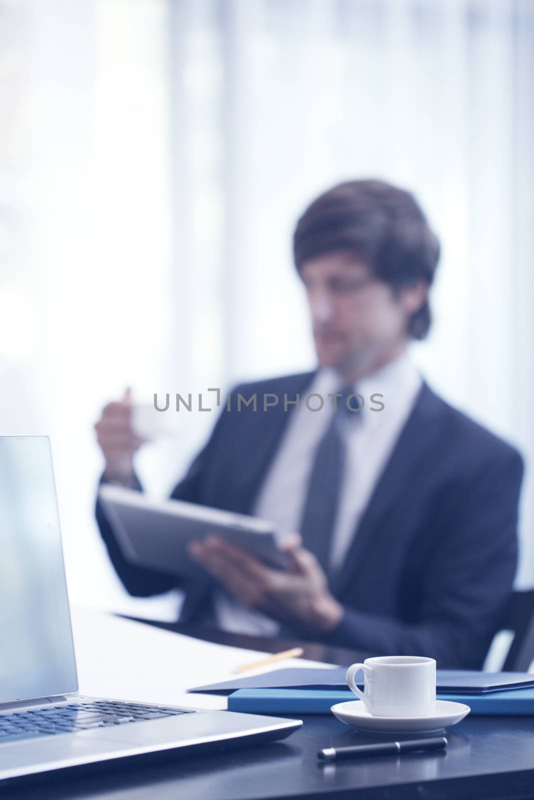 Business man with tablet computer in office