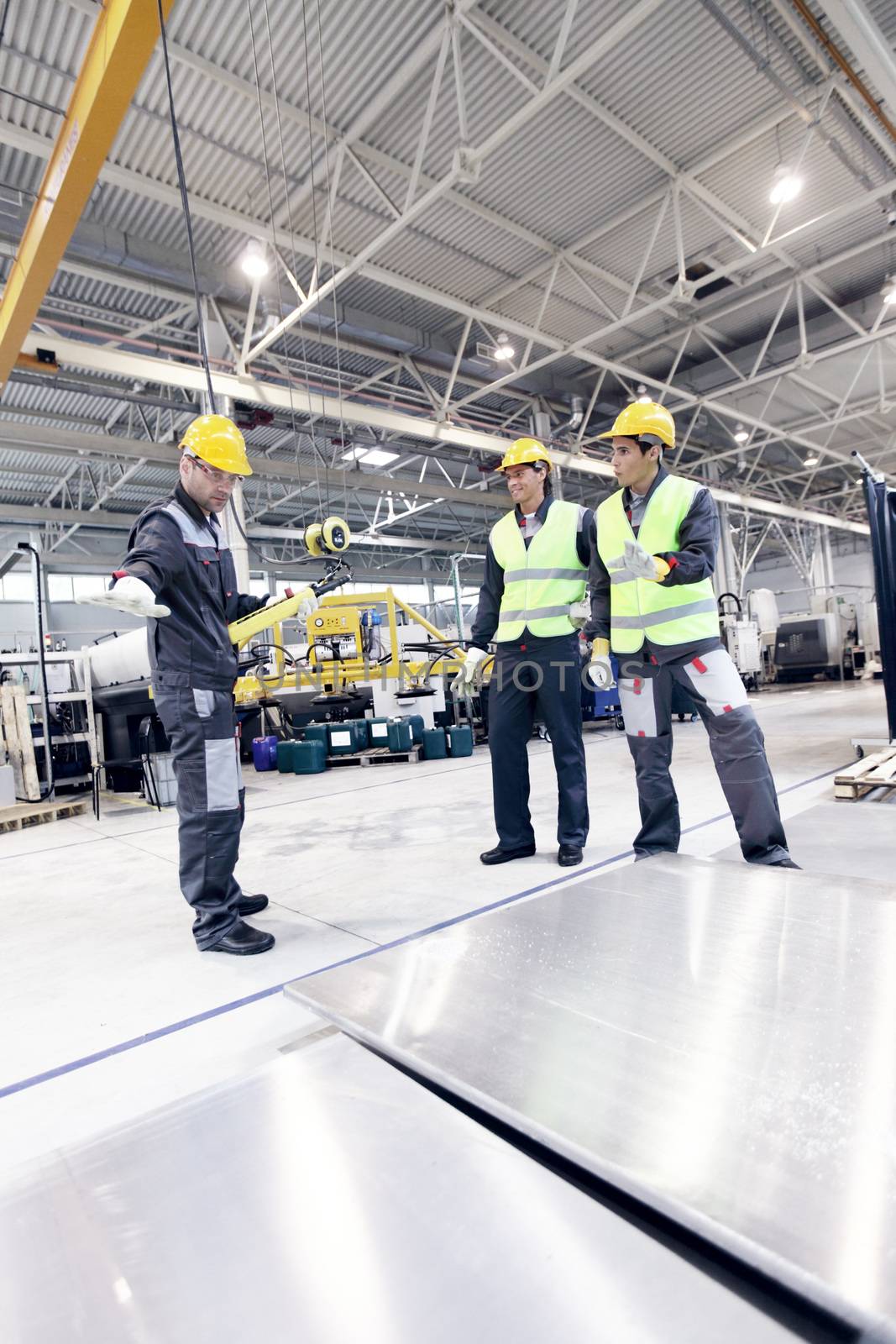 Workers working with aluminium billets by ALotOfPeople