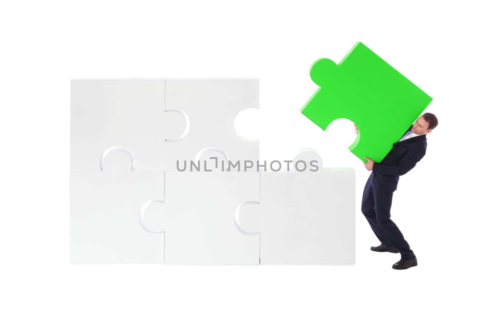 Business man assembling puzzle by ALotOfPeople