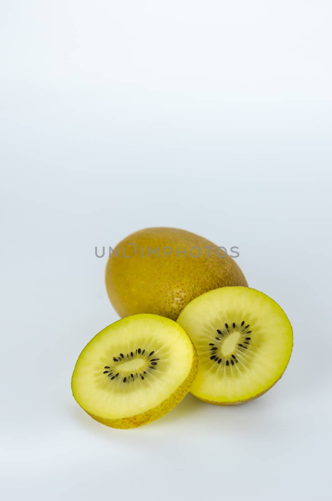 delicious whole kiwi fruit and half on white background