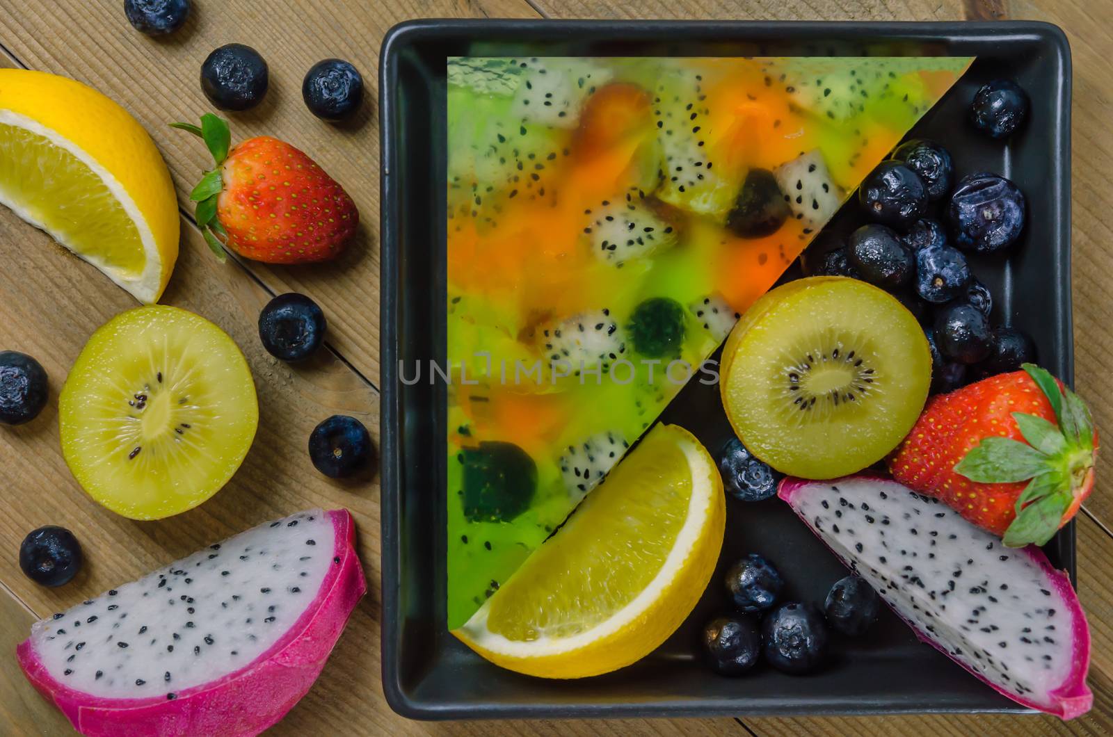 Top view of mixed jelly fruits ( strawberry, blueberry, kiwi, orange, dragon fruit )