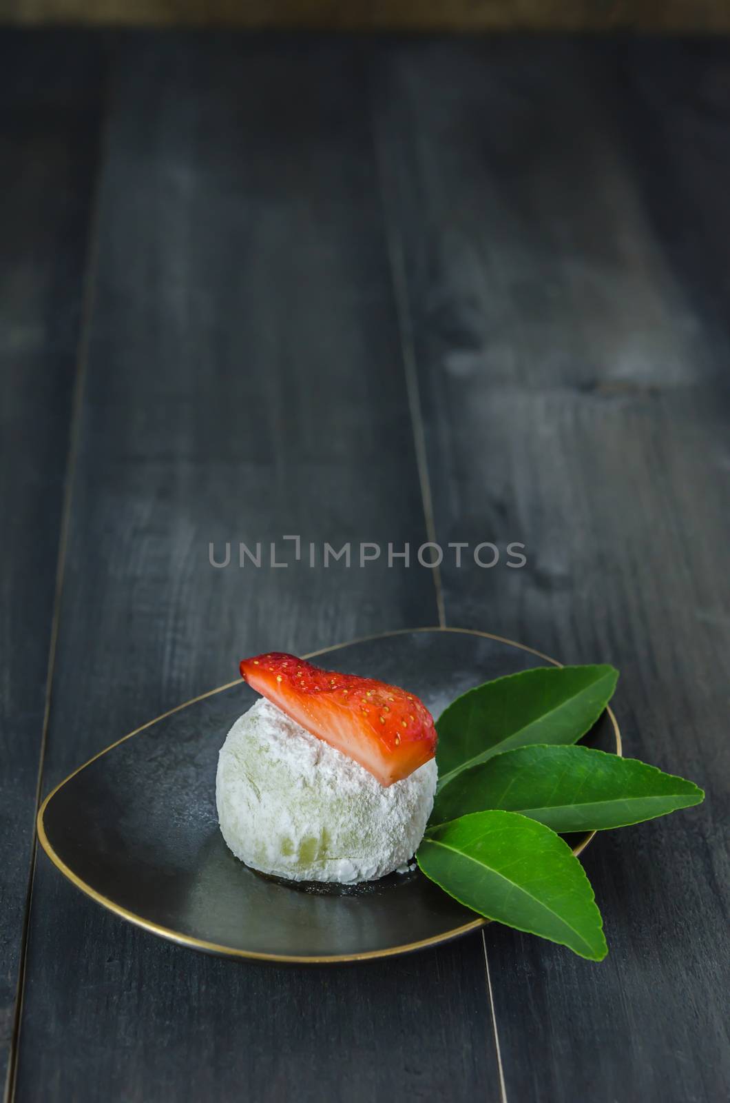 Strawberry Daifuku Mochi Japanese dessert on dish over wooden background