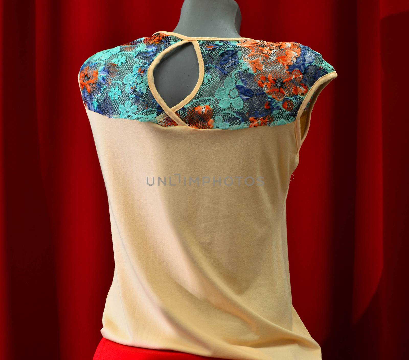 picture of a fashion summer clothes on a manequin doll on a red background