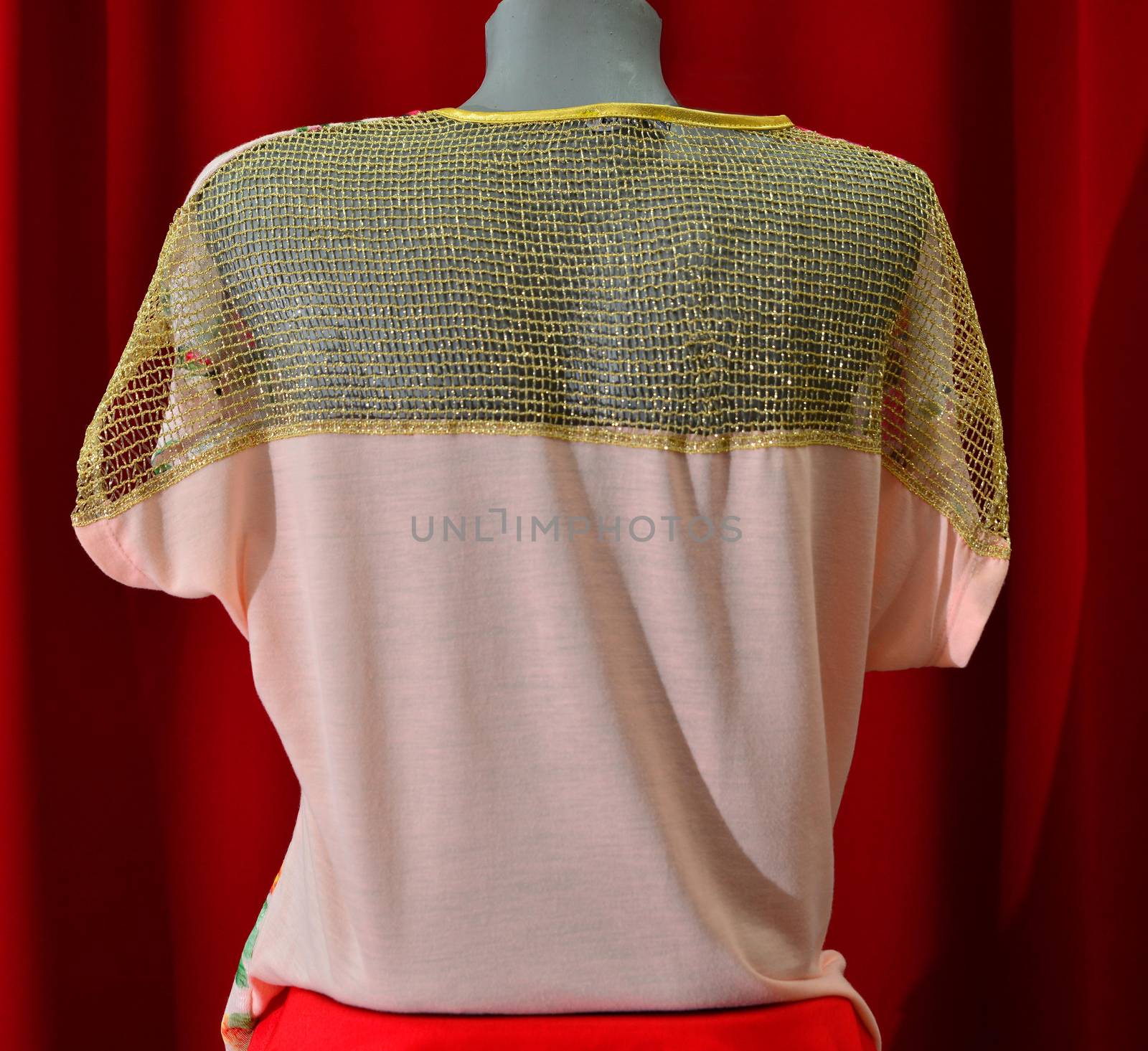 picture of a fashion summer clothes on a manequin doll on a red background