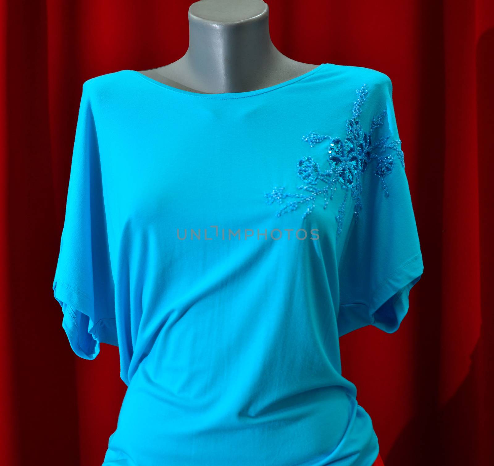 picture of a fashion summer clothes on a manequin doll on a red background