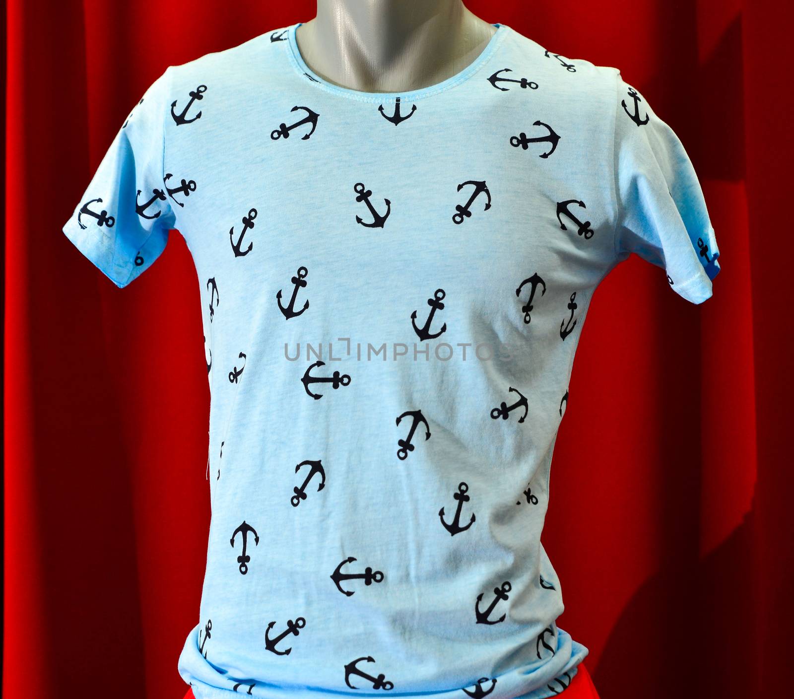 picture of a fashion summer clothes on a manequin doll on a red background