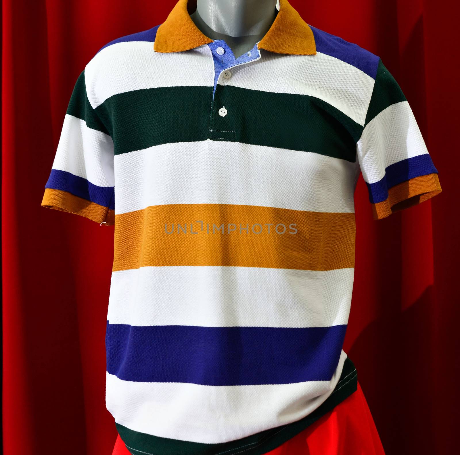 picture of a fashion summer clothes on a manequin doll on a red background