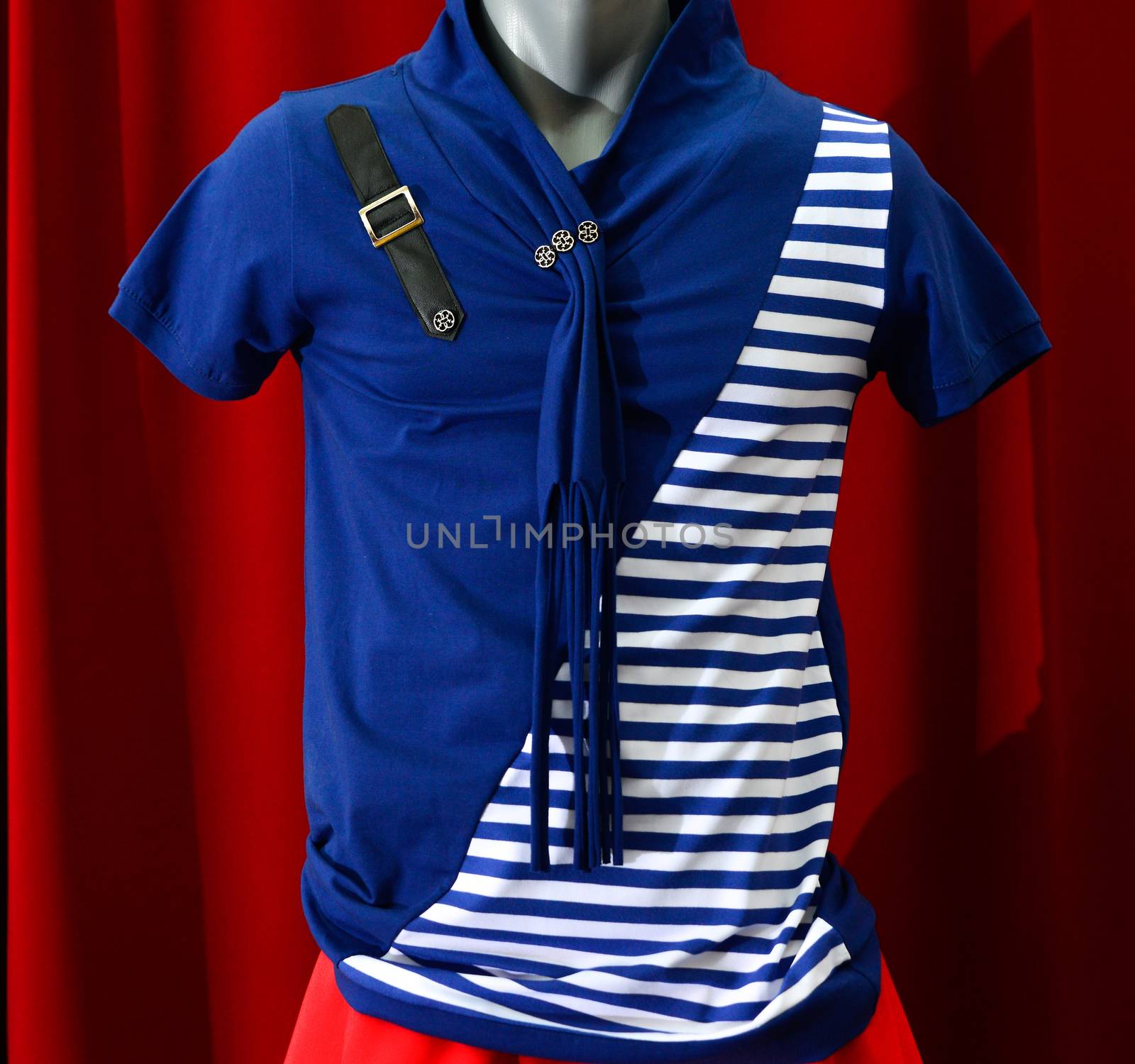 picture of a fashion summer clothes on a manequin doll on a red background