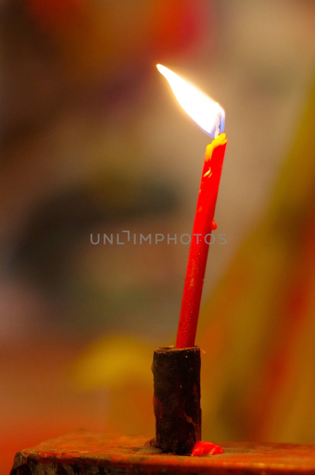 red burning, long candles in budist temple by evolutionnow