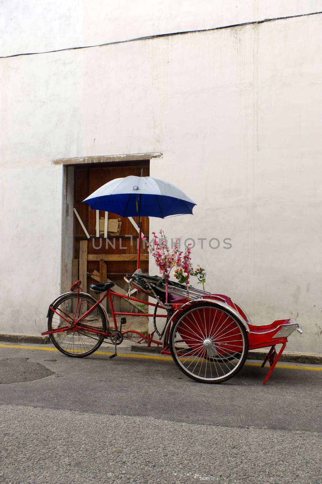 Georgetown, Penang, Malaysia - April 18, 2015: Classic local rickshaw in George Town, Penang in Malaysia