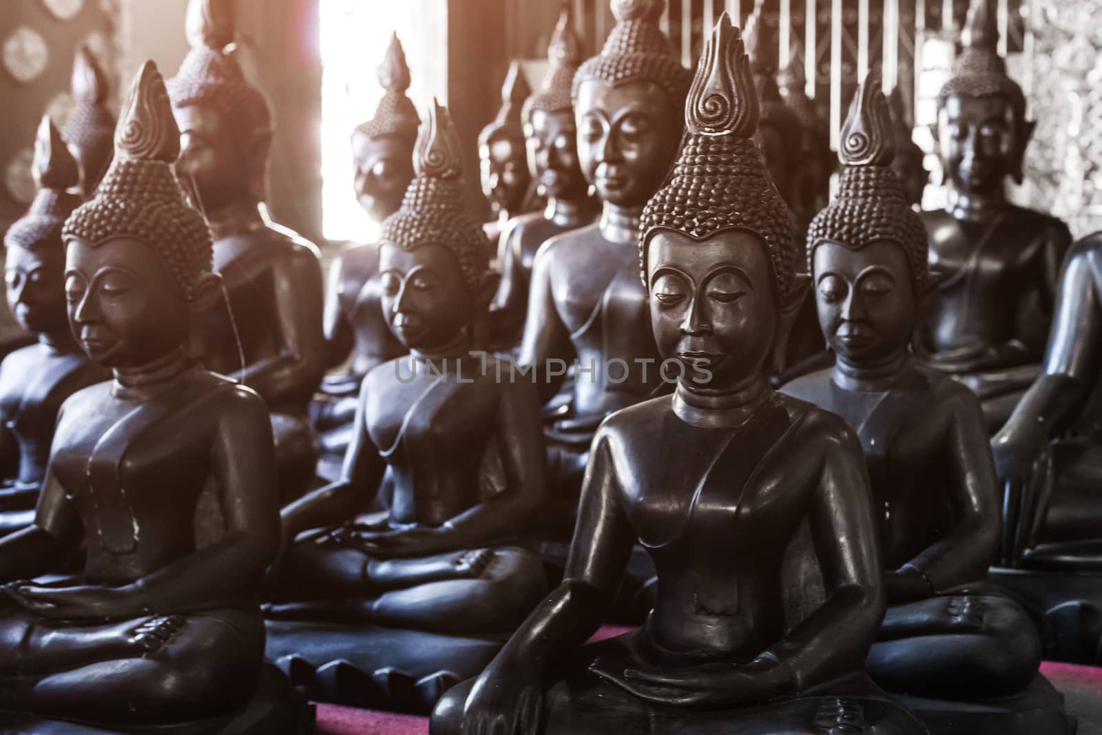 Black Buddha statues by nopparats