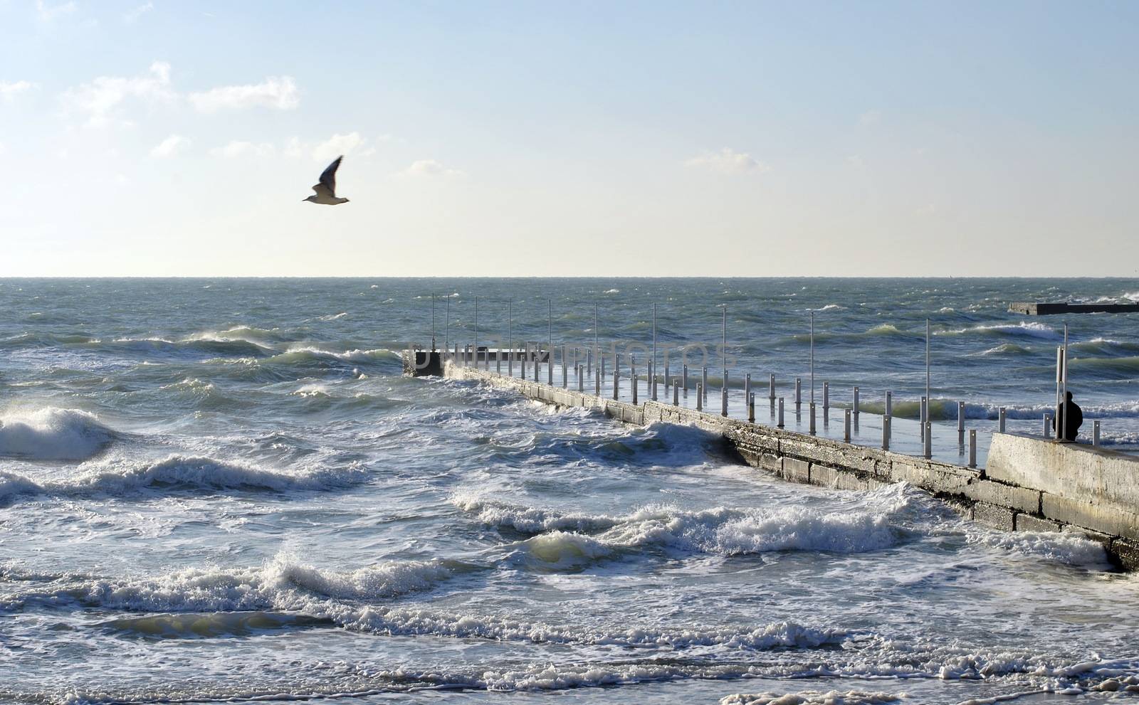 Sea wave splashing against a pier in Odessa. Black Sea.