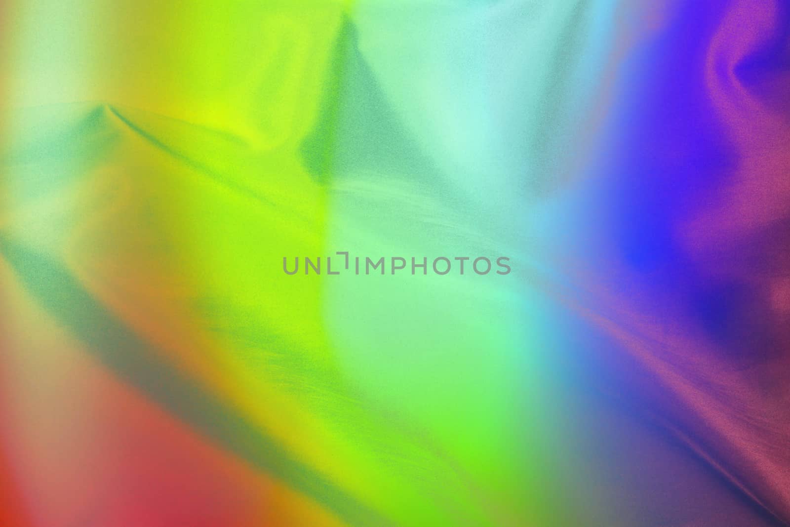 An abstract background of a soft satin cloth in rainbow colors