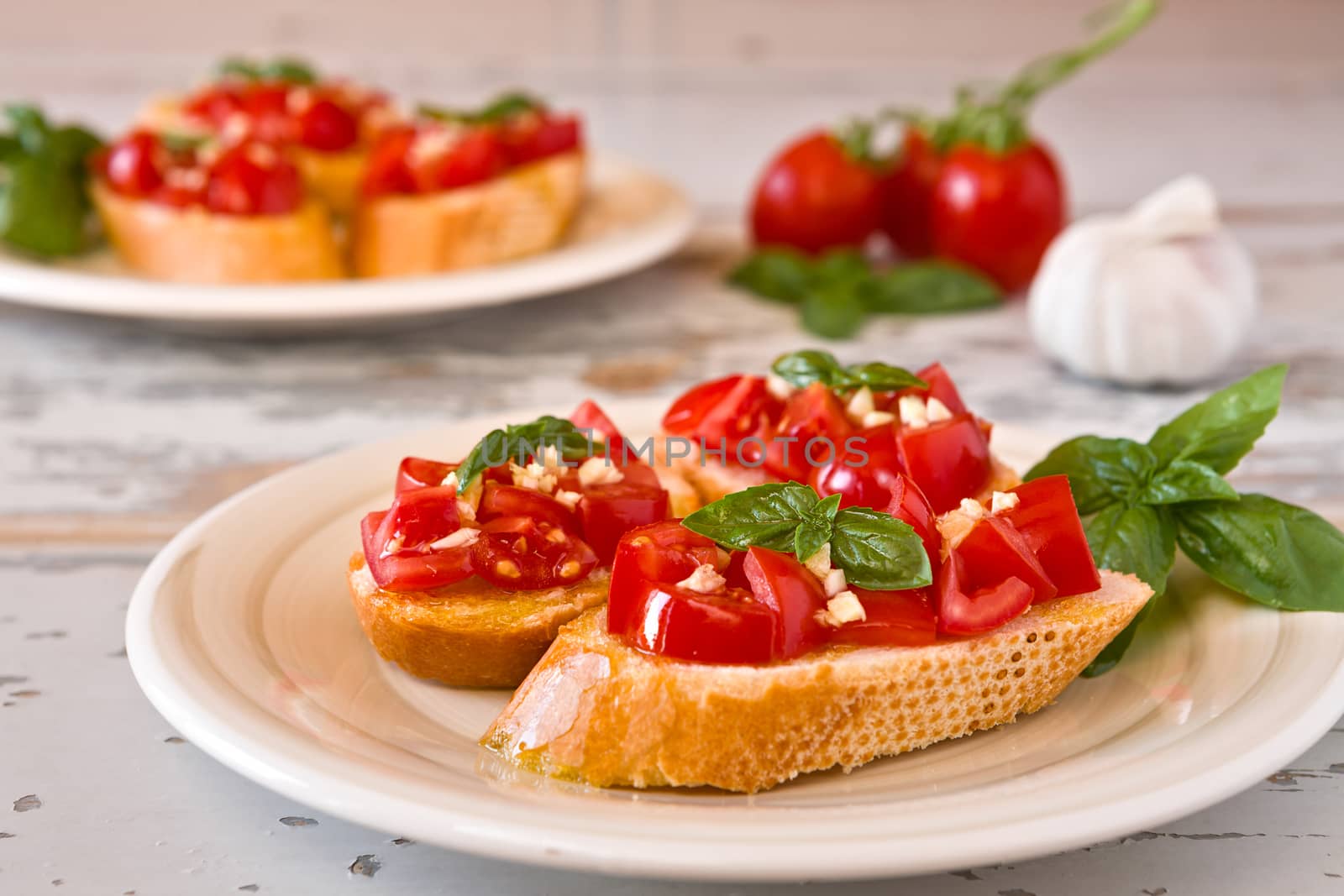 Closeup of Italian bruschetta with tomato, basil and garlic on a plate