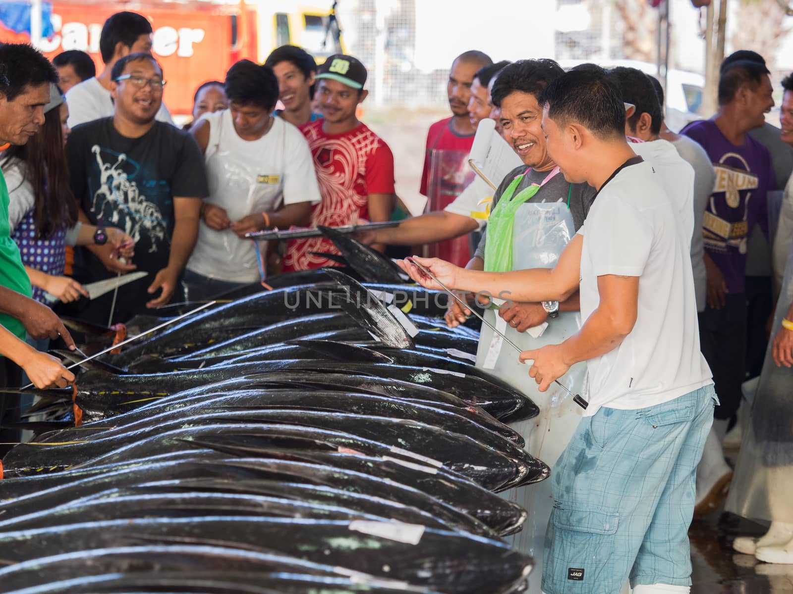 General Santos City - September 1, 2016: Buyers and sellers checking the quality of yellowfin tuna at the Tuna Harbor in General Santos City, South Cotabato, The Philippines. General Santos is the Tuna Capital of The Philippines, and the tuna industry is an important contributor the the city’s economy with export worldwide.