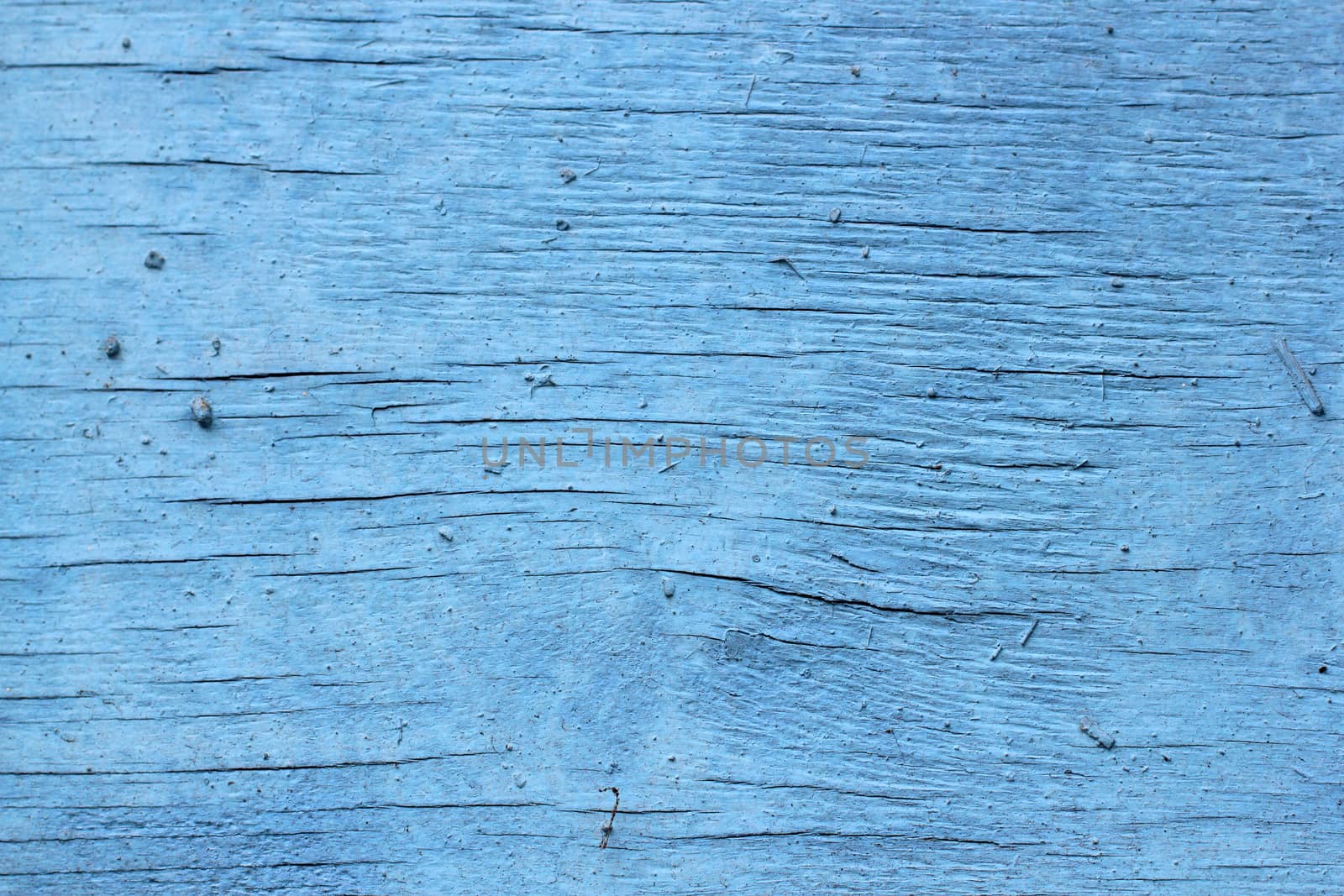 old wooden background with cracked blue paint