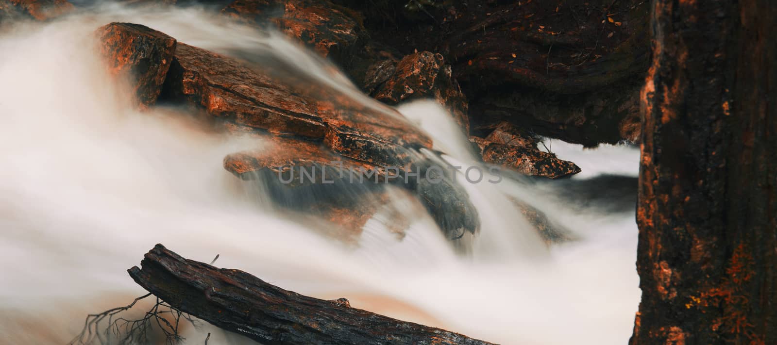 Knyvet Falls in Cradle Mountain, Tasmania after heavy rainfall with abstract red hues added.