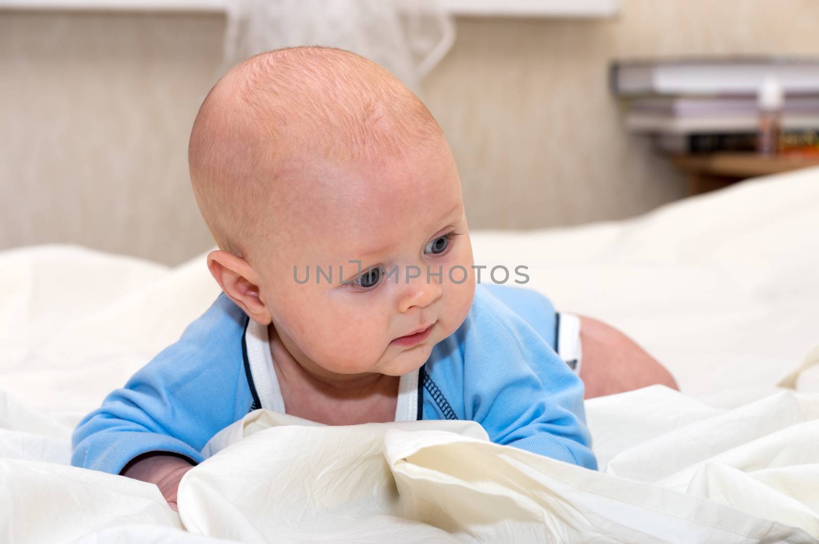 Indoor close up shot of boy lying on stomach