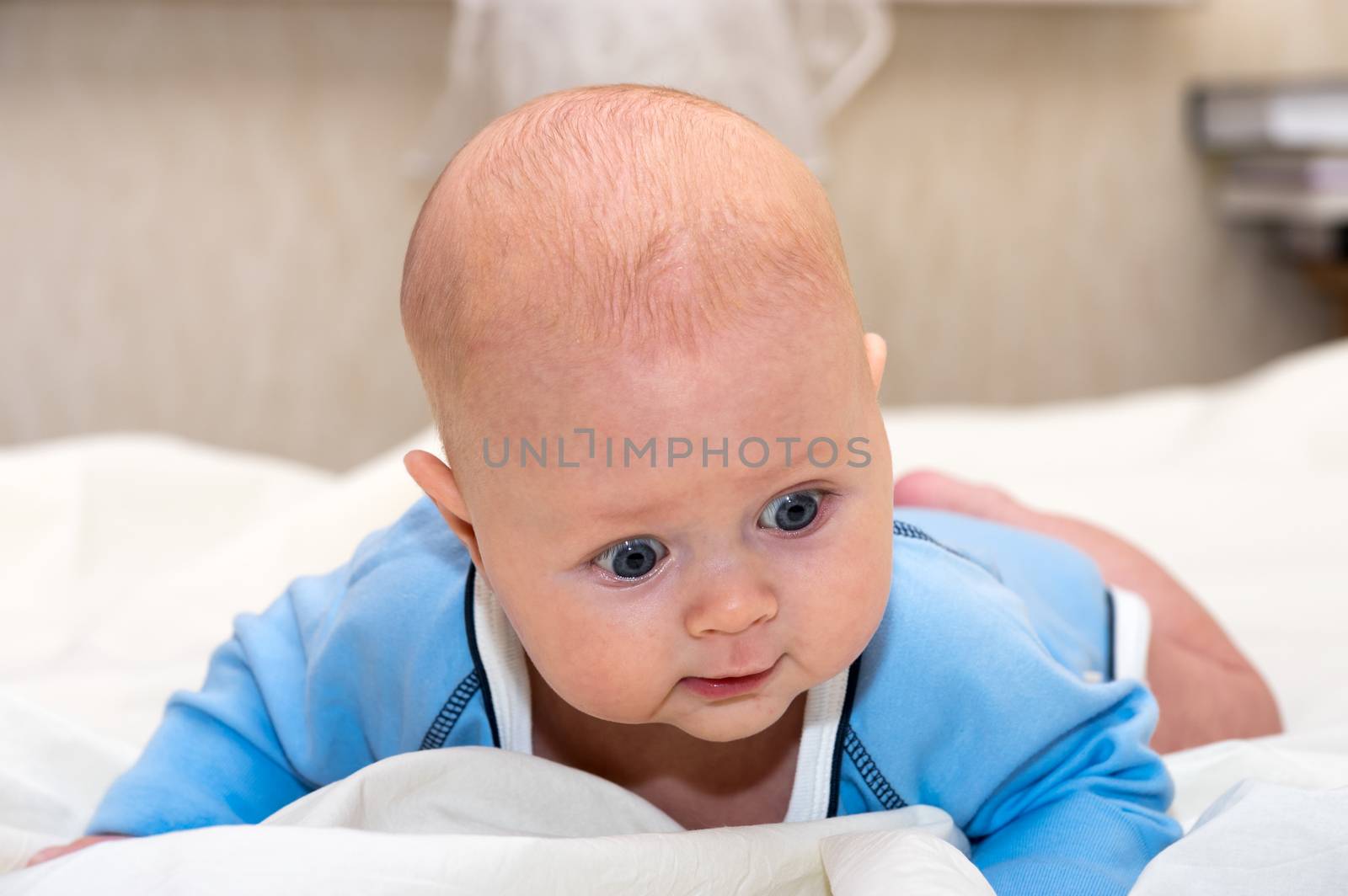 Close up shot of boy lying on stomach