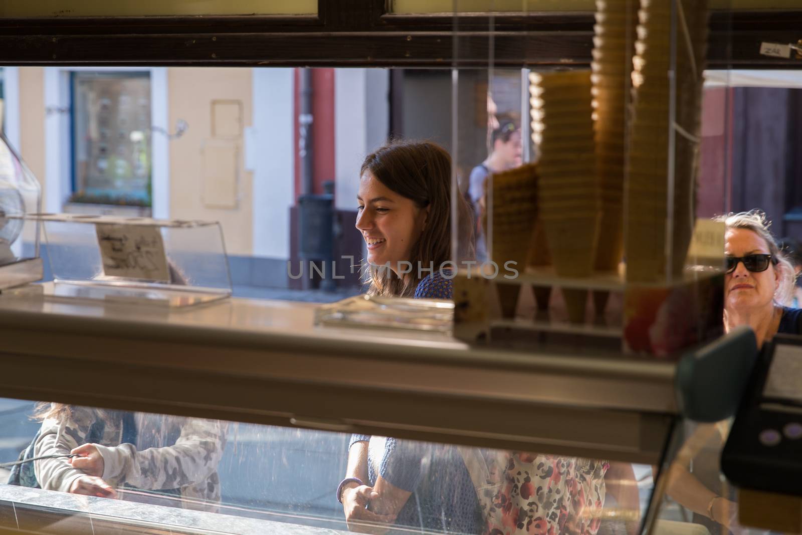 Girl smiling, buying ice cream. Beautiful smile of a young girl. She buys ice cream. by AndrewBu