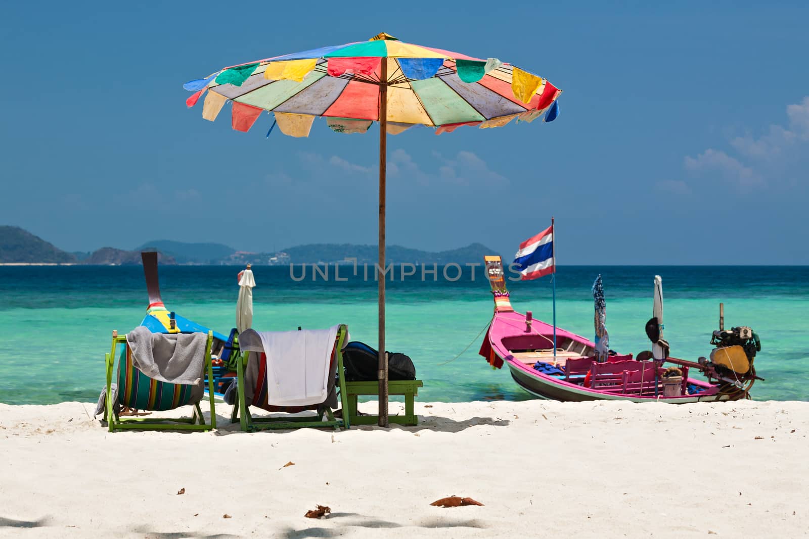 Beach umbrella and chairs in Coral island, Thailand by LuigiMorbidelli