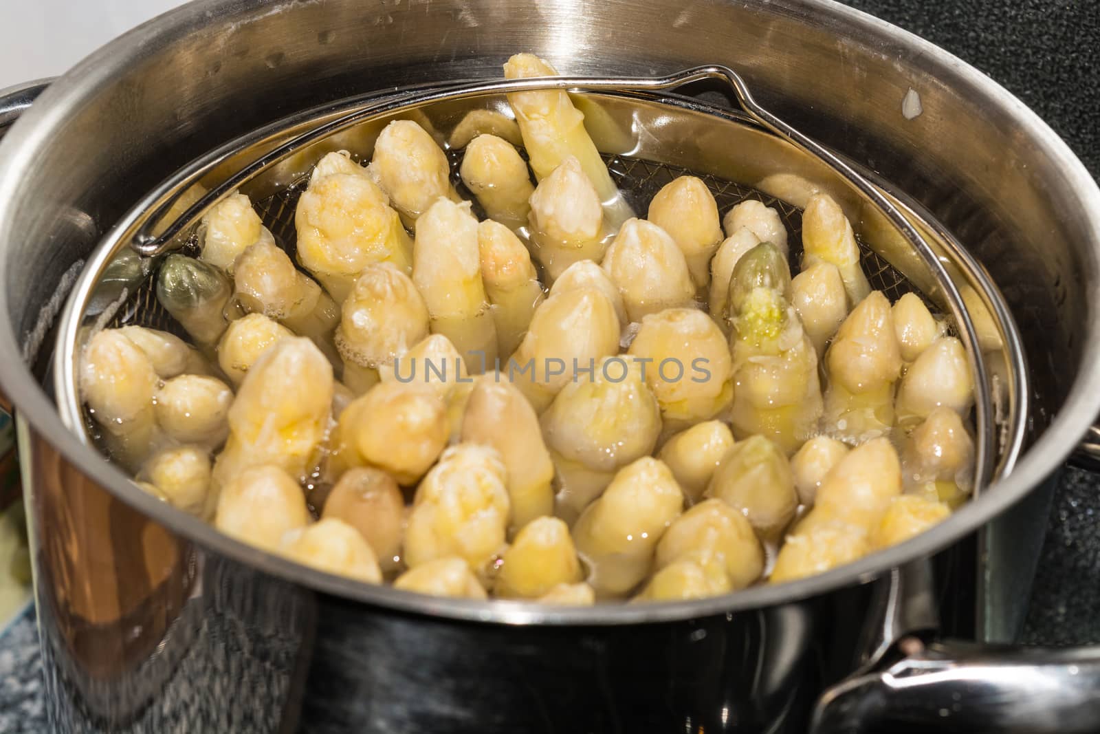 White asparagus in a special asparagus pot.