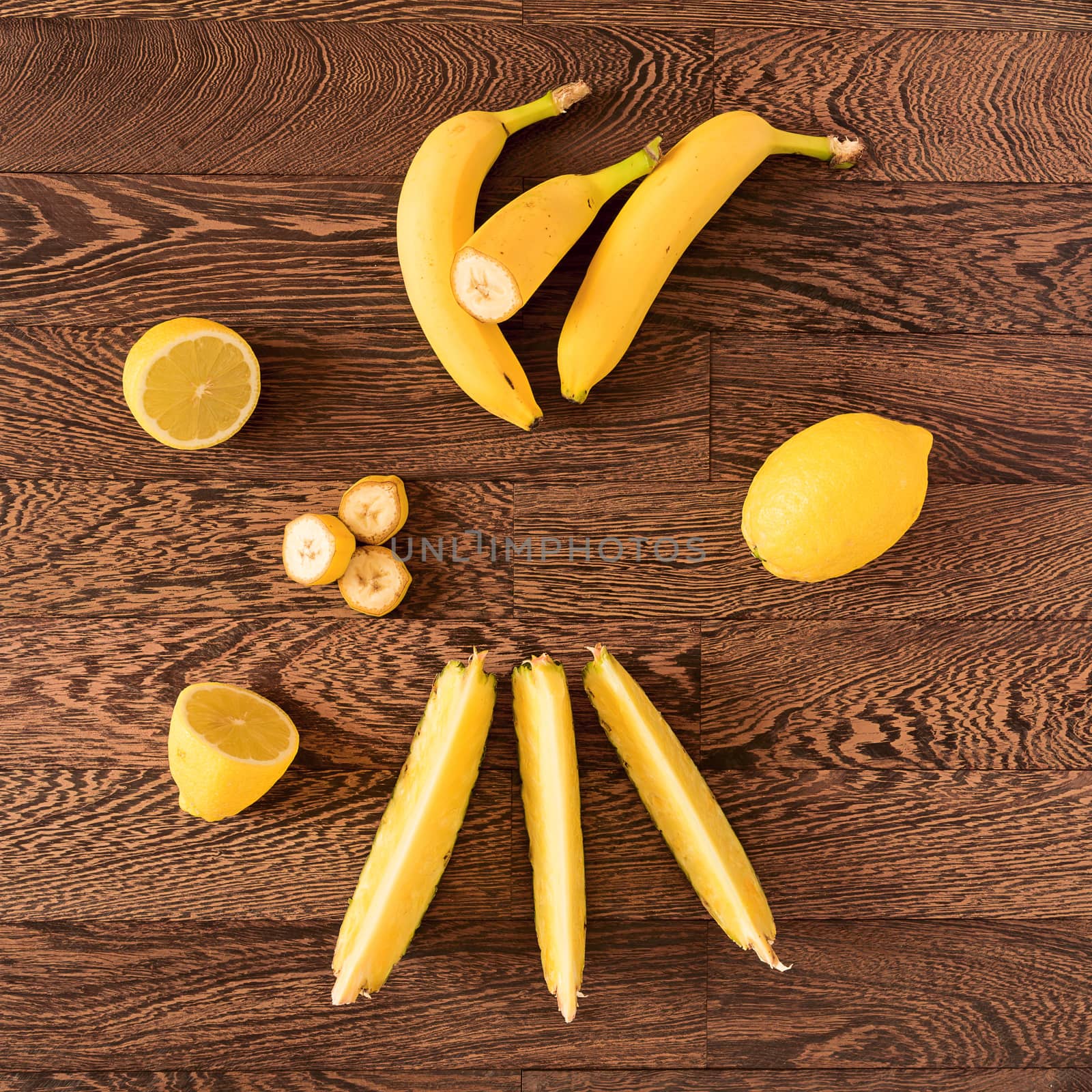 Fresh yellow toned fruits over a wooden background