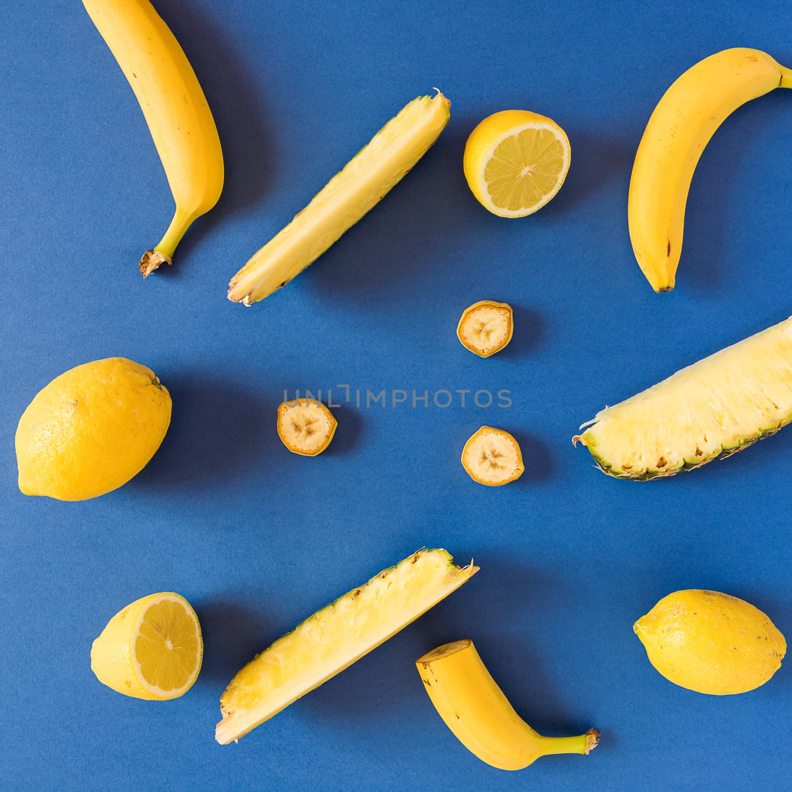 Yellow colored fruit over a blue background