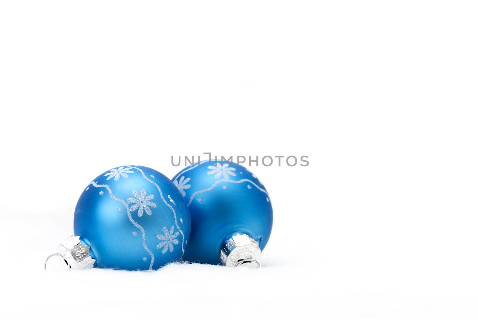 Two blue glass christmas balls with a snowflake motif.