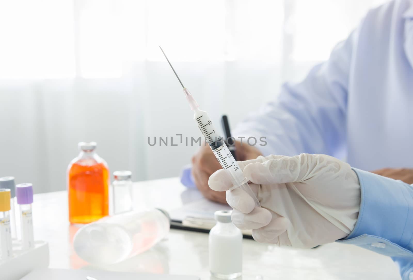 Doctor holding medical injection syringe in hospital. healthcare and medical concept