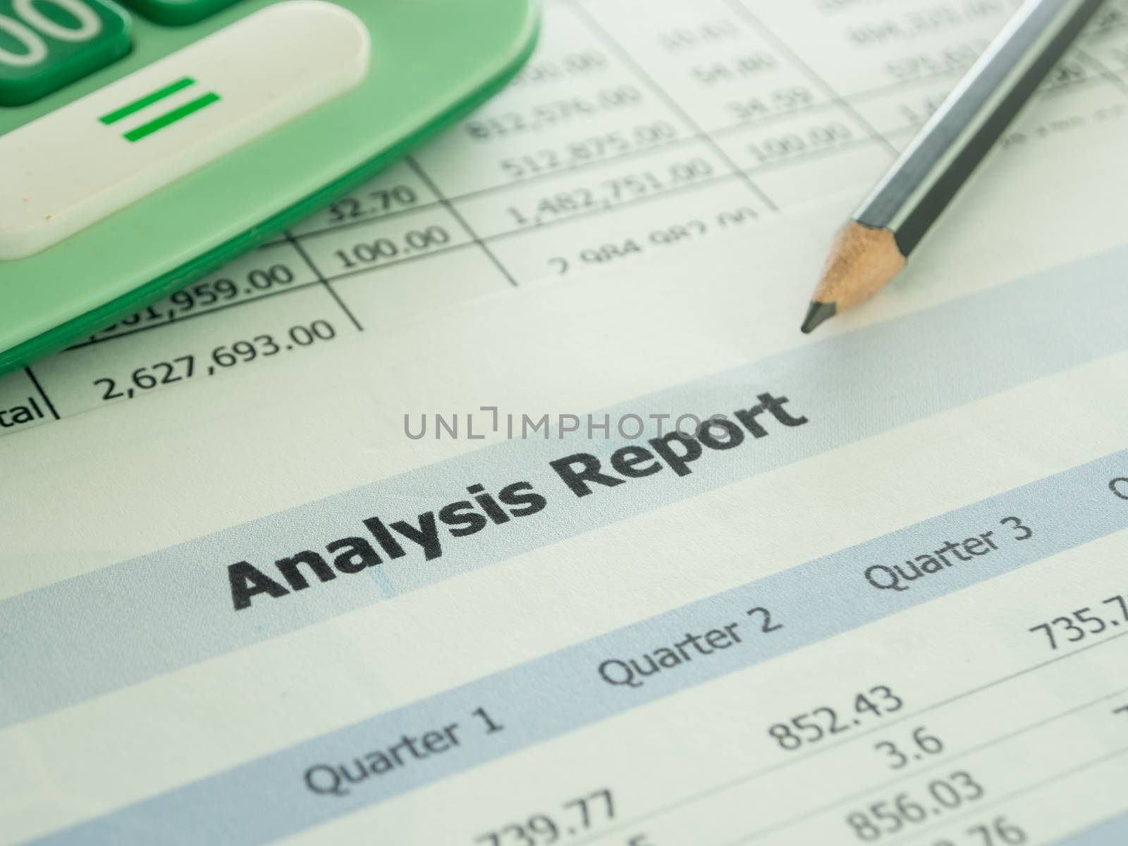 Marketer's desk with analysis Report ,Calculator, pencil.