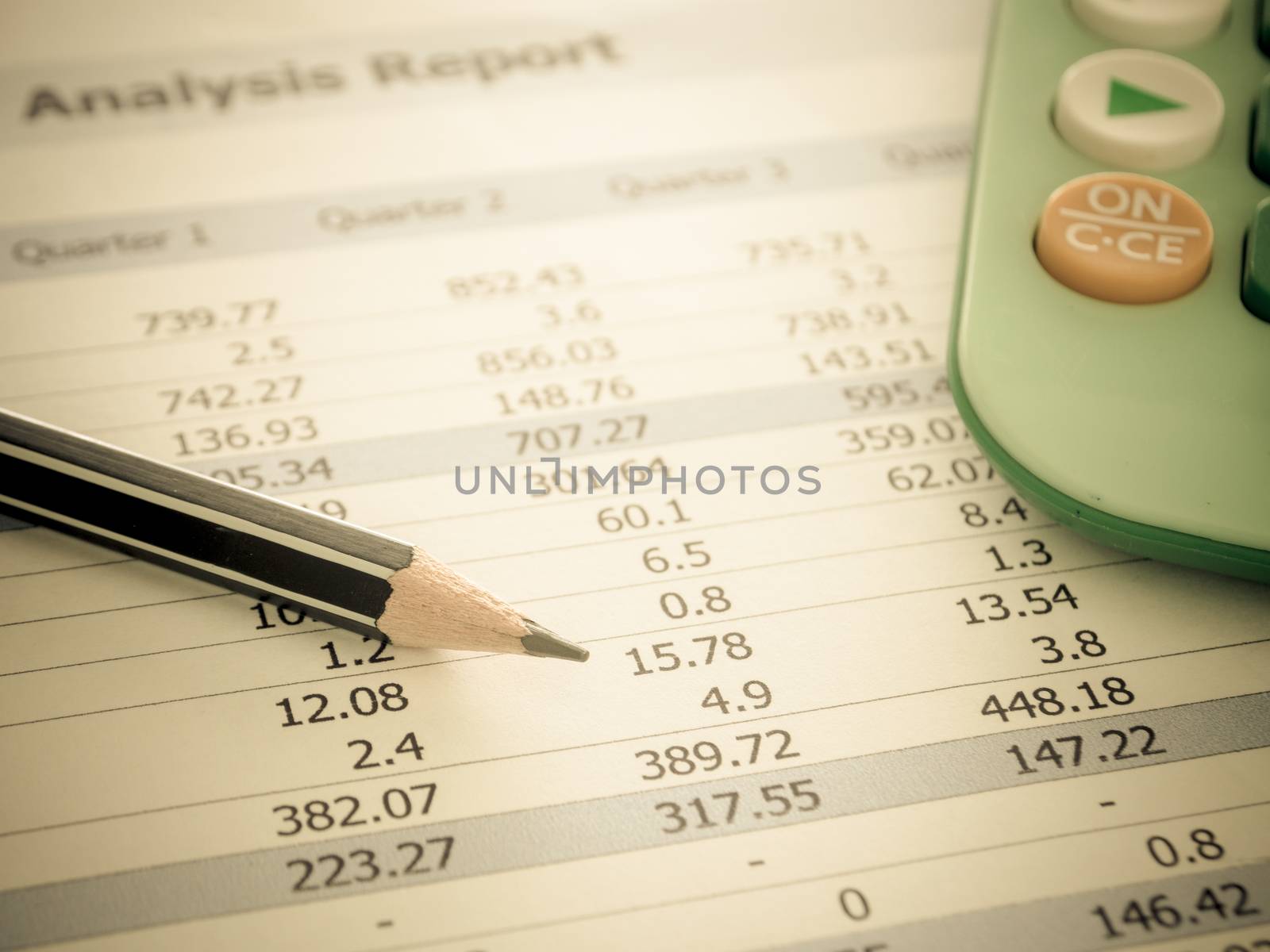 Marketer's desk with analysis Report ,Calculator, pencil.
