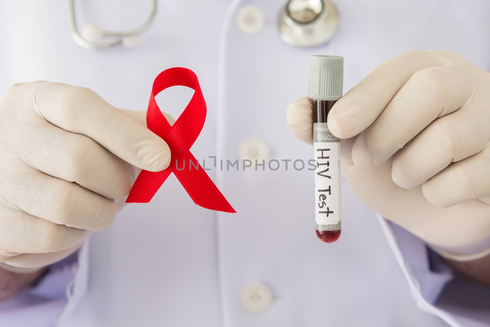 doctors hands holding red ribbon and  blood sample for hiv test. World AIDS Day concepts.