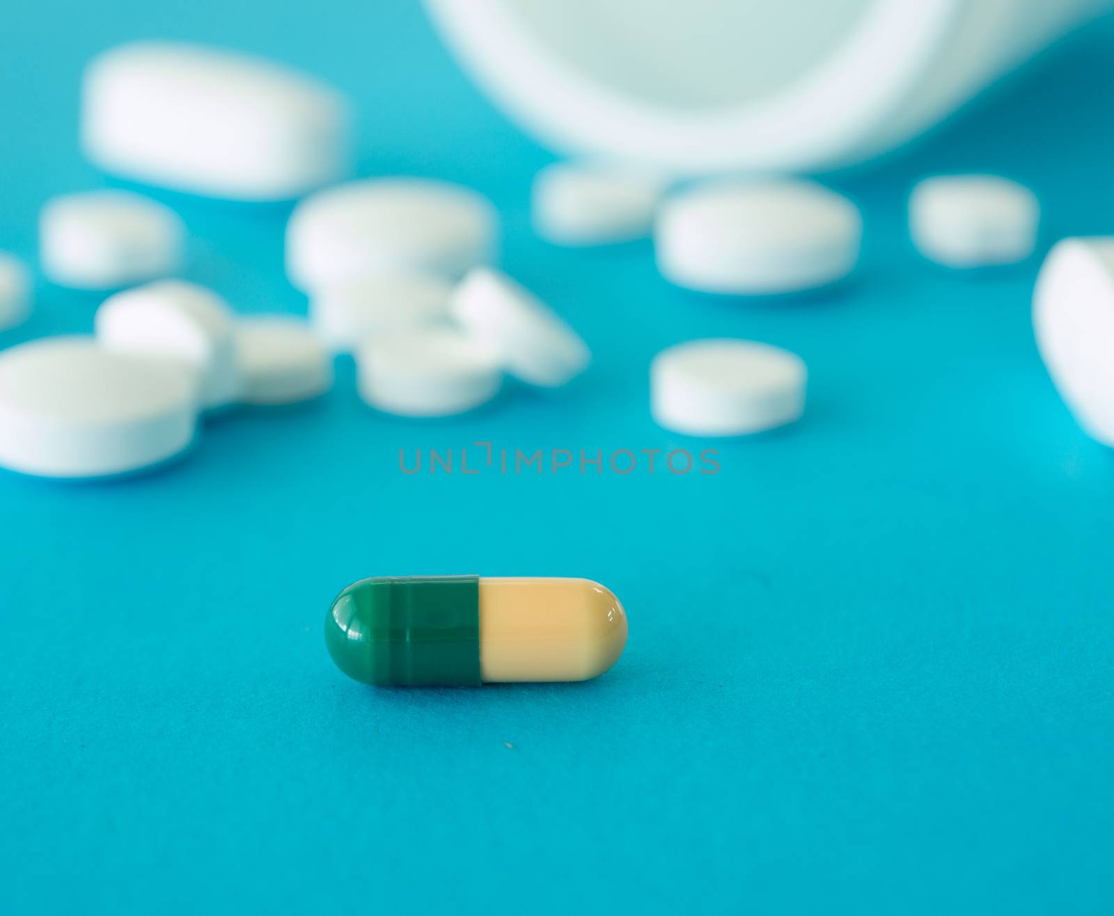 capsule pill on blue blackground. selective focus.