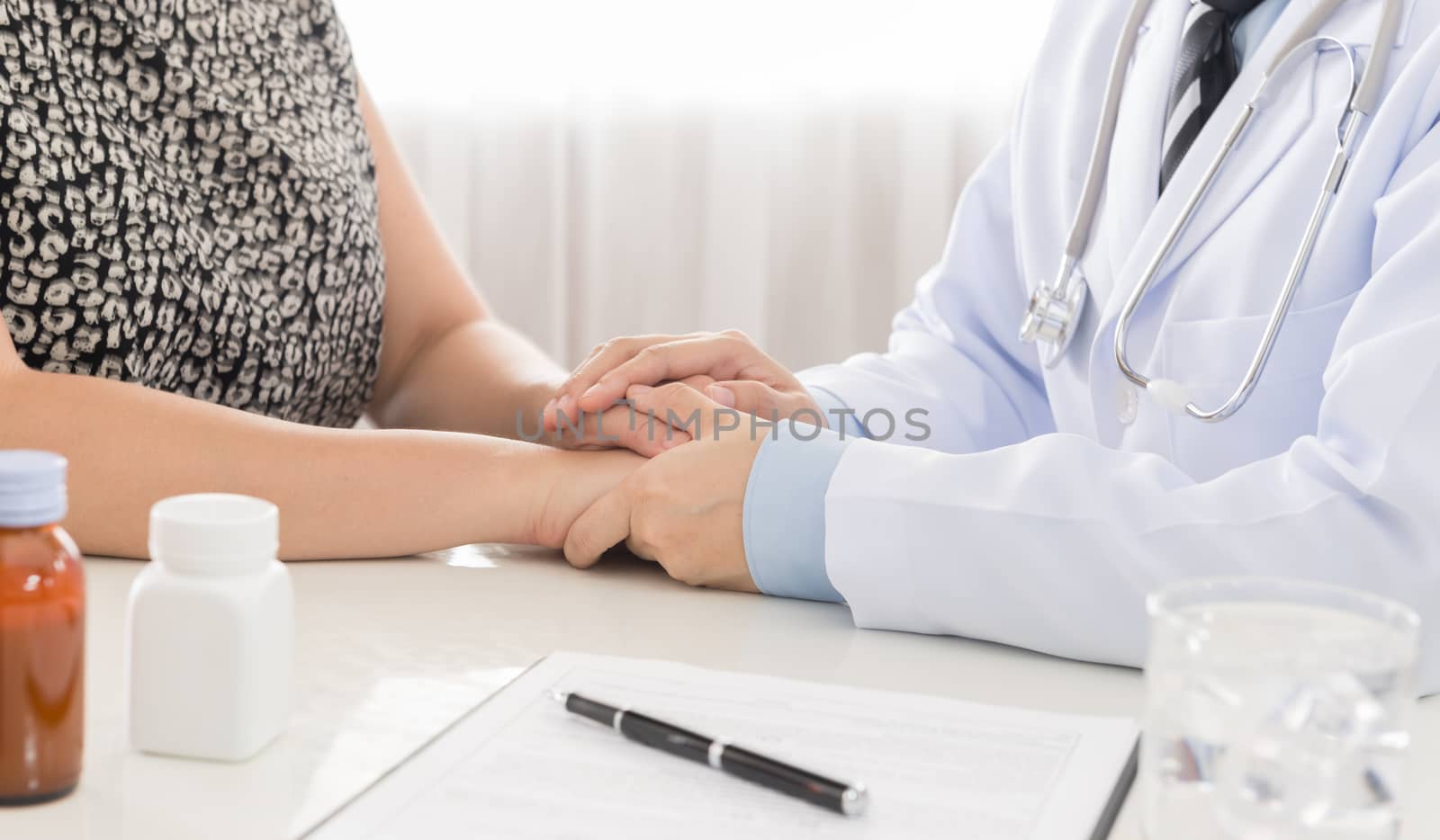 Hand of doctor comforting her female patient