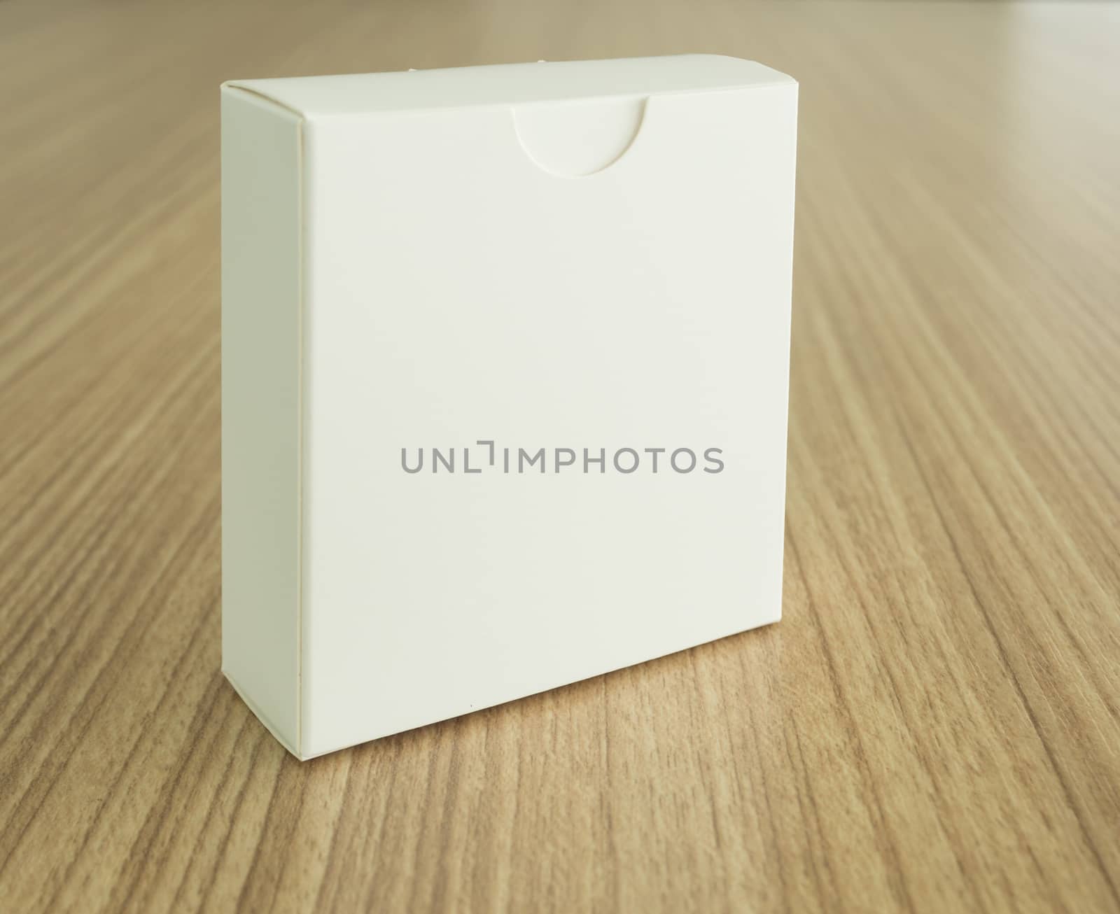 White Cardboard Package Box on wooden background. free space for your design