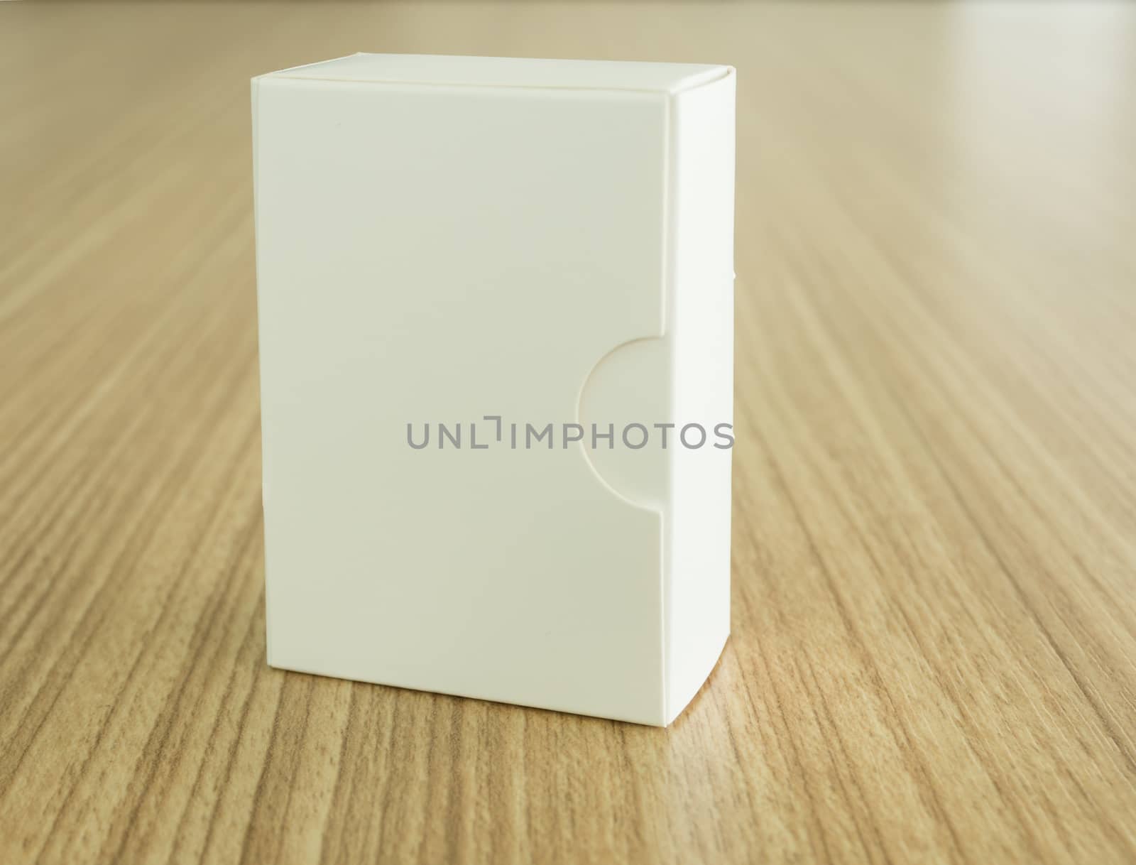 White Cardboard Package Box on wooden background. free space for your design