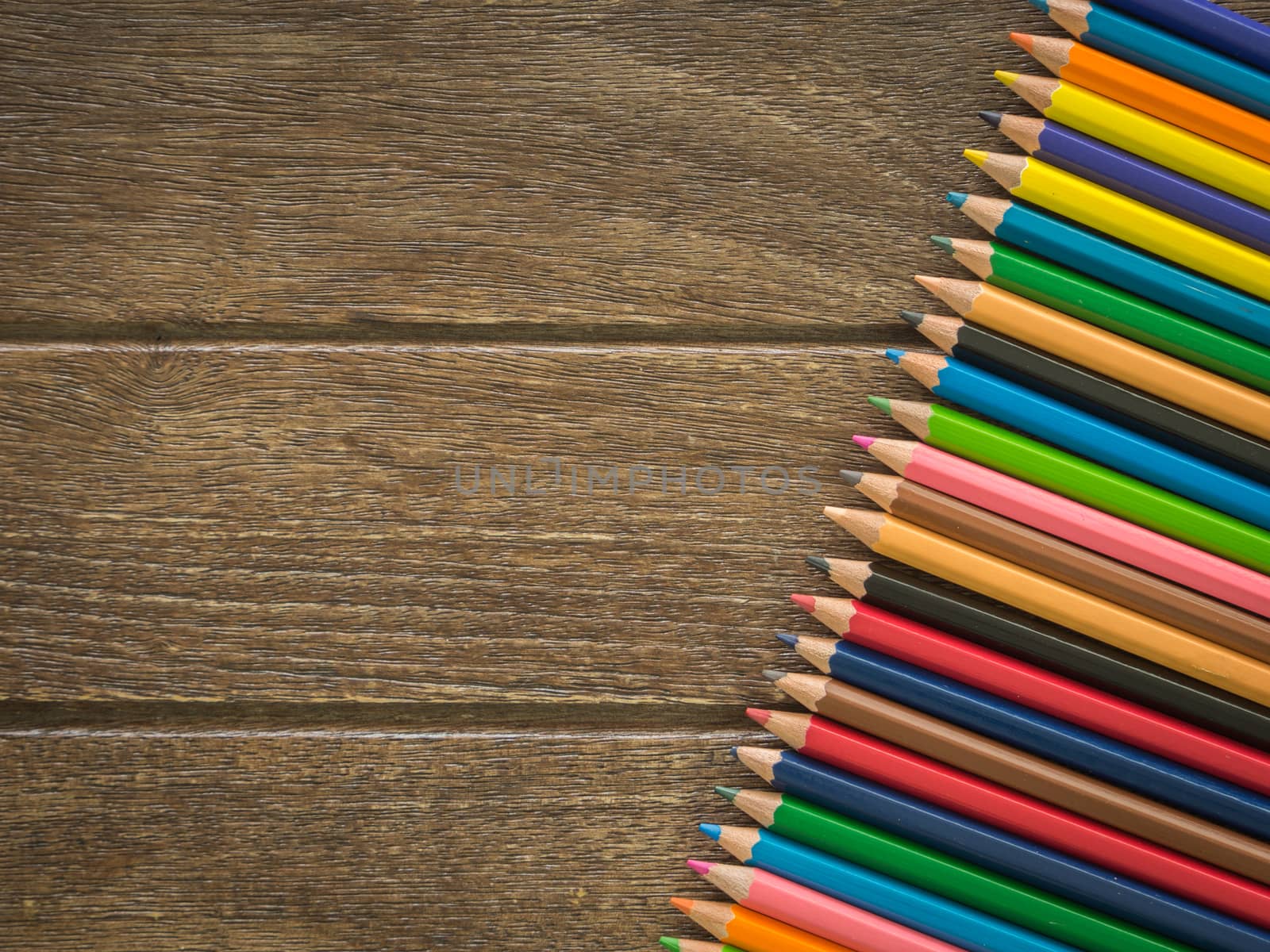crayons put on a wooden board view from top. free space for text. educations concept, back to school concept.