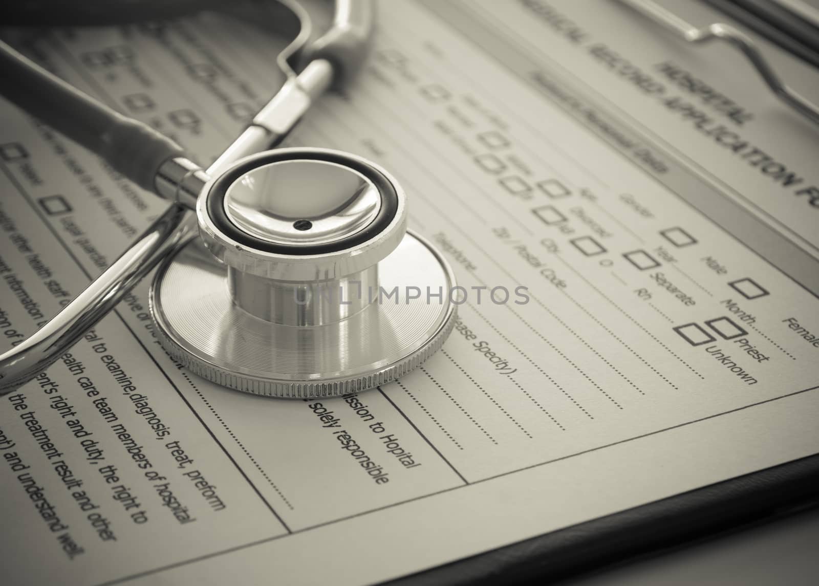 stethoscope with medical record application form on physicians desk