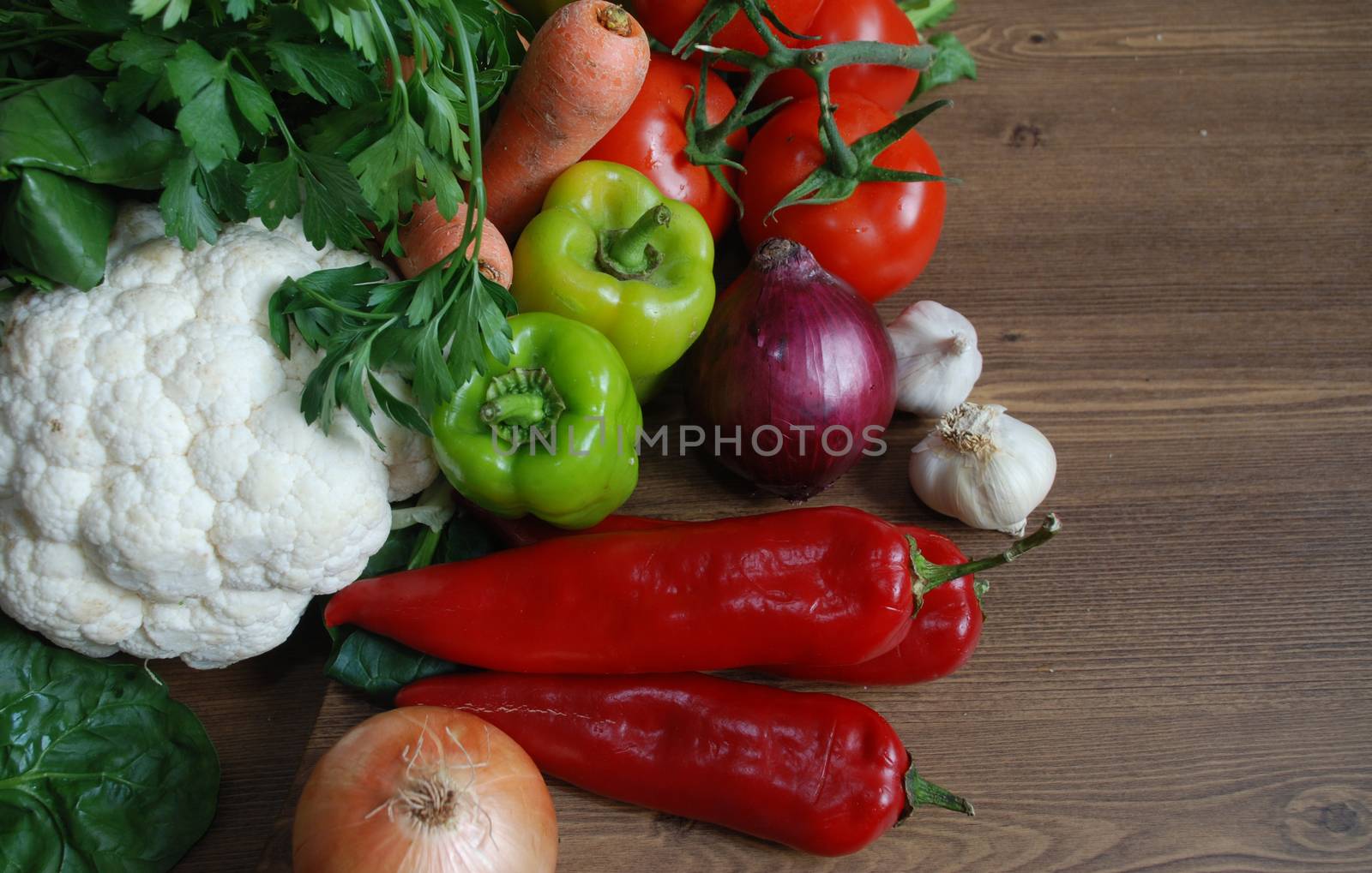 Healthy organic  Assortment of fresh vegetables on dark wooden table.