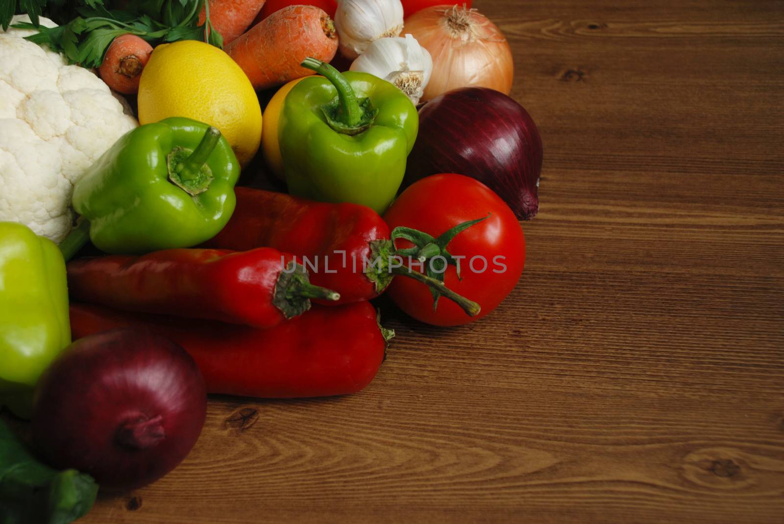 Healthy organic  Assortment of fresh vegetables on dark wooden table.