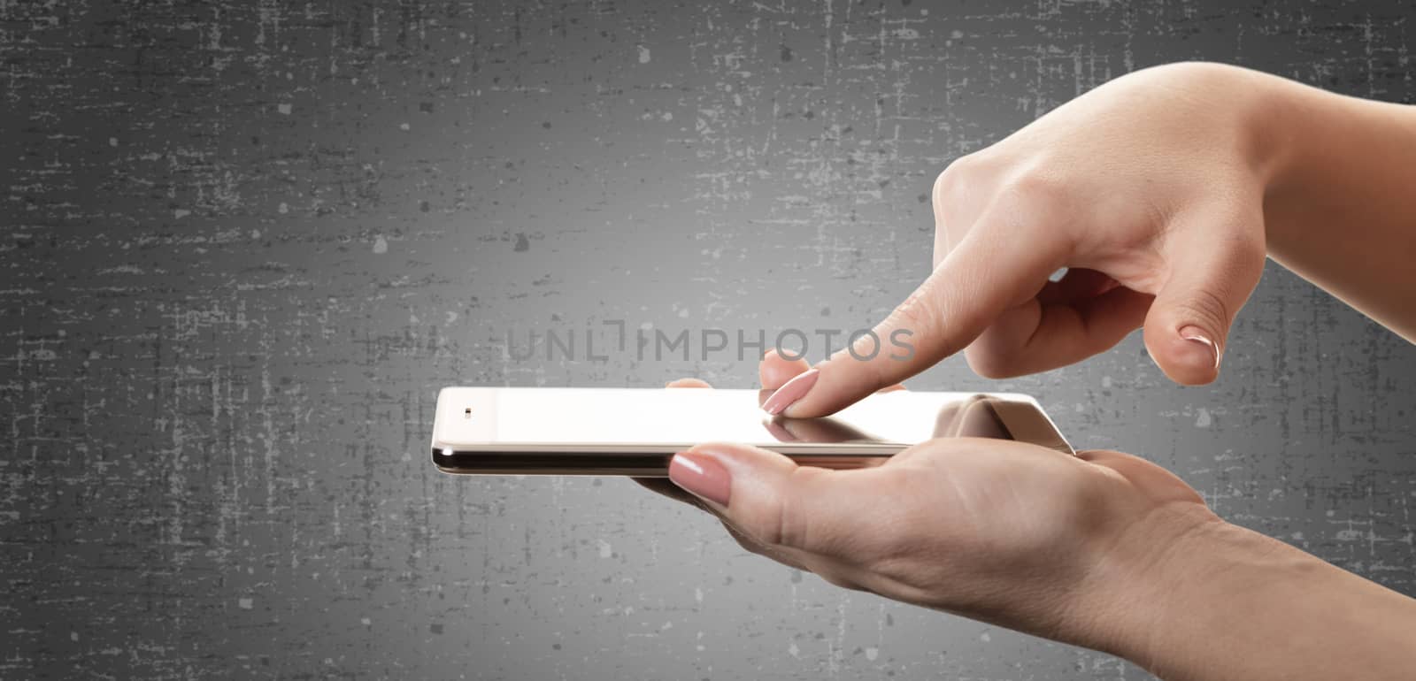 smartphone in a female hand on black background