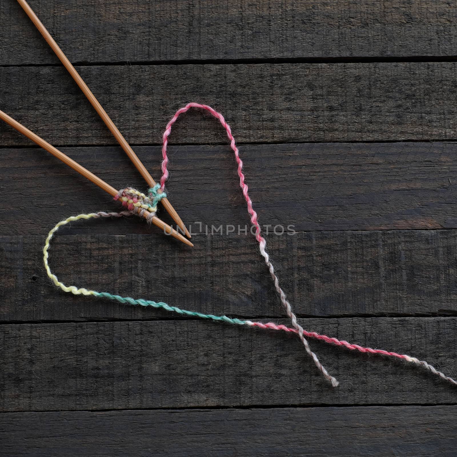 Knitted background with knitting needle and ball of yarn, knit is hobby, leisure activities of many people in free time, also make many handmade product