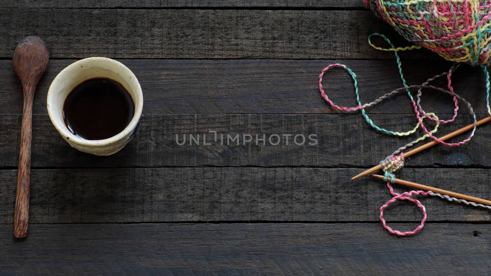 Knitted background with needle, yarn, coffee cup by xuanhuongho