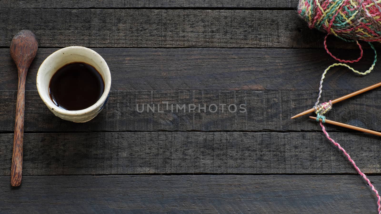 Knitted background with needle, yarn, coffee cup by xuanhuongho