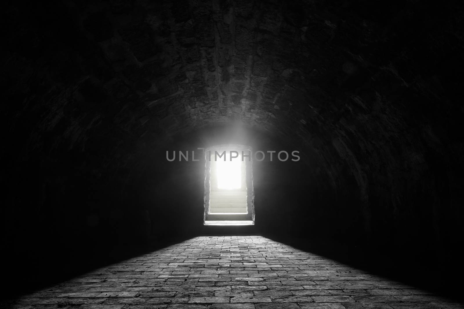 Interior image with a medieval german wine cellar, with its stone floor and the sunlight at the entrance